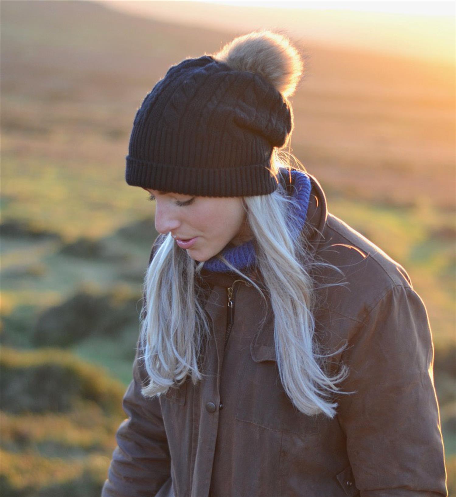 A young woman looking pensive on a sunset evening